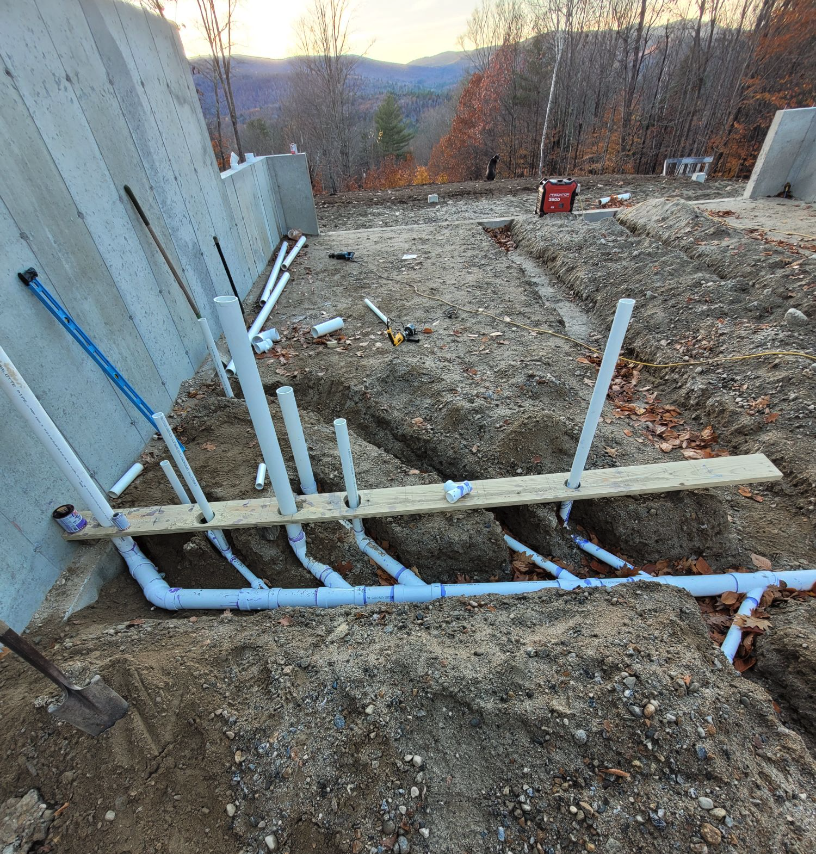 plumbing pipes installed under a concrete slab